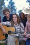 woman on guitar with guests