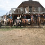 wranglers holding hats up at Big Bar Guest Ranch