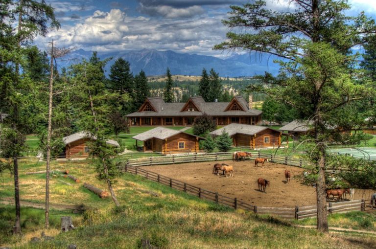 horses on ranch with beautiful cabins and mountains