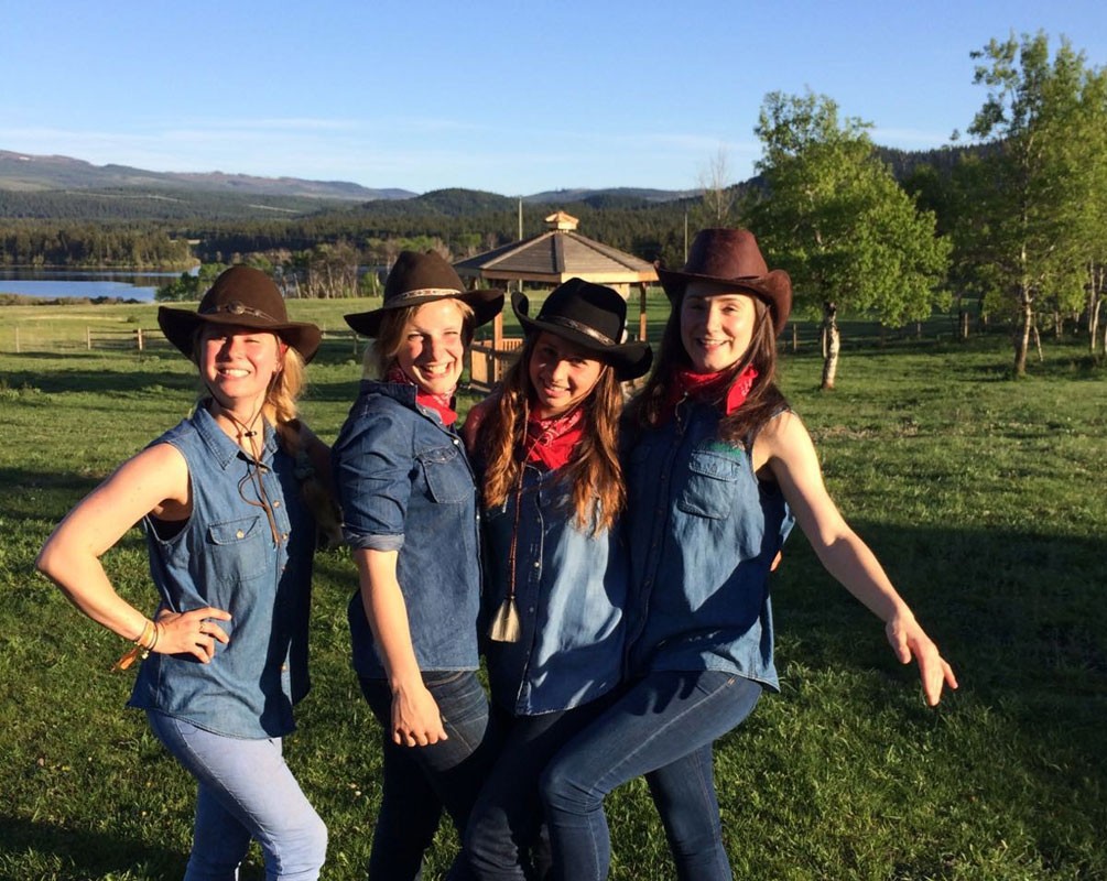 girls dressed as ranchers smiling and posing